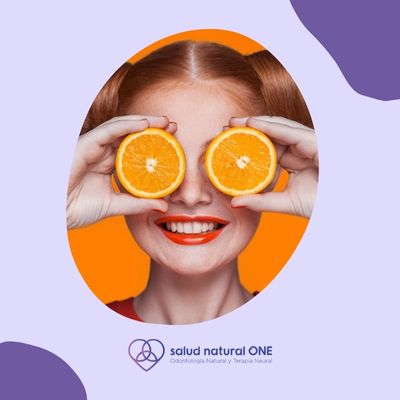 imagen de una mujer sonriendo con dos naranjas con vitamina c